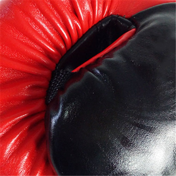 Close-up of red adult boxing gloves, showcasing the durable PU material and padded design for fitness and martial arts.